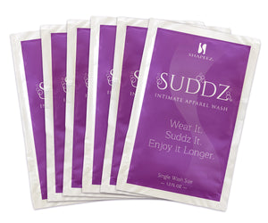 A set of six purple sachets labeled "Suddz: Intimate Apparel & Lingerie Wash Packet" from Shapeez. The front text includes "Wear It. Suddz It. Enjoy it Longer." Each sachet, designed as a delicate garments detergent with 1.3 fl oz, is neatly arranged in a slightly overlapping pattern.