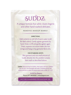 A white packet labeled "Shapeez Suddz: Intimate Apparel & Lingerie Wash Packet" containing an intimate apparel wash formula for cleaning lingerie and other hand-washed delicates. Includes directions for use in warm water, instructions for stubborn spots, and a caution against machine use. Contact info and company details at the bottom.