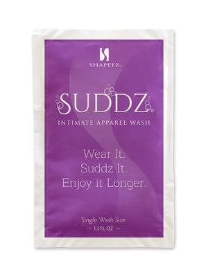 A single-use packet of Suddz: Intimate Apparel & Lingerie Wash Packet by Shapeez. The packet is purple with white text reading "Sudz Intimate Apparel Wash" and below it, "Wear It. Sudz It. Enjoy it Longer." This delicate garments detergent contains 1.3 fl oz and is intended for single wash use.